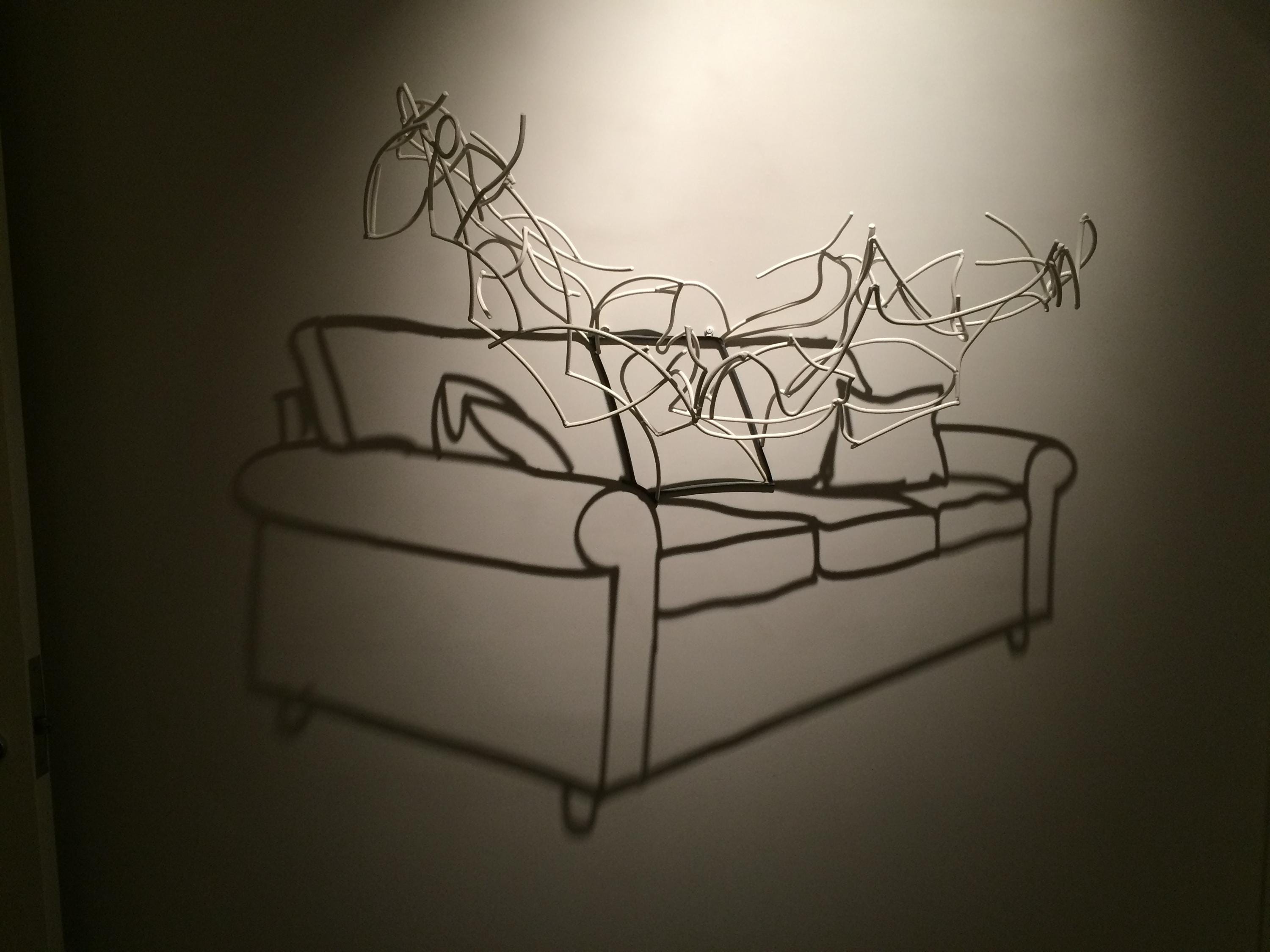 Larry Kagan wire sculpture, shadow of a couch on a wall